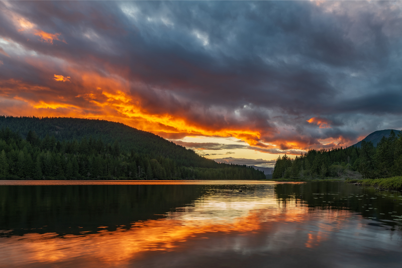 Amazing orange sunset over lake with reflection at Inland Lake Provincial Park one of the top 5 places for camping in BC